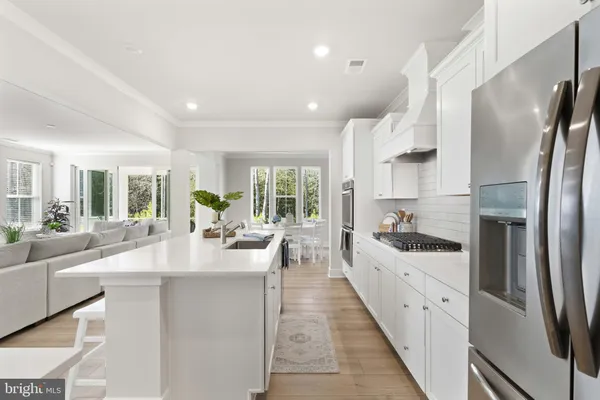 a large kitchen with stainless steel appliances lots of counter space and windows