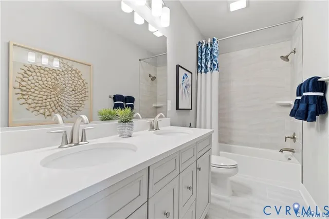 a bathroom with a sink a toilet a mirror and shower