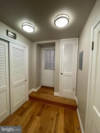 a view of a room with wooden floor