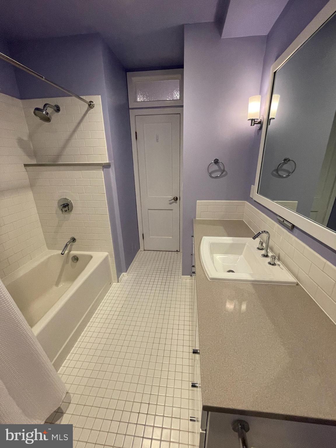 2442 20th Street Northwest, Unit B Washington, DC 20009 - Photo 8 of 19 a bathroom with a tub sink and mirror