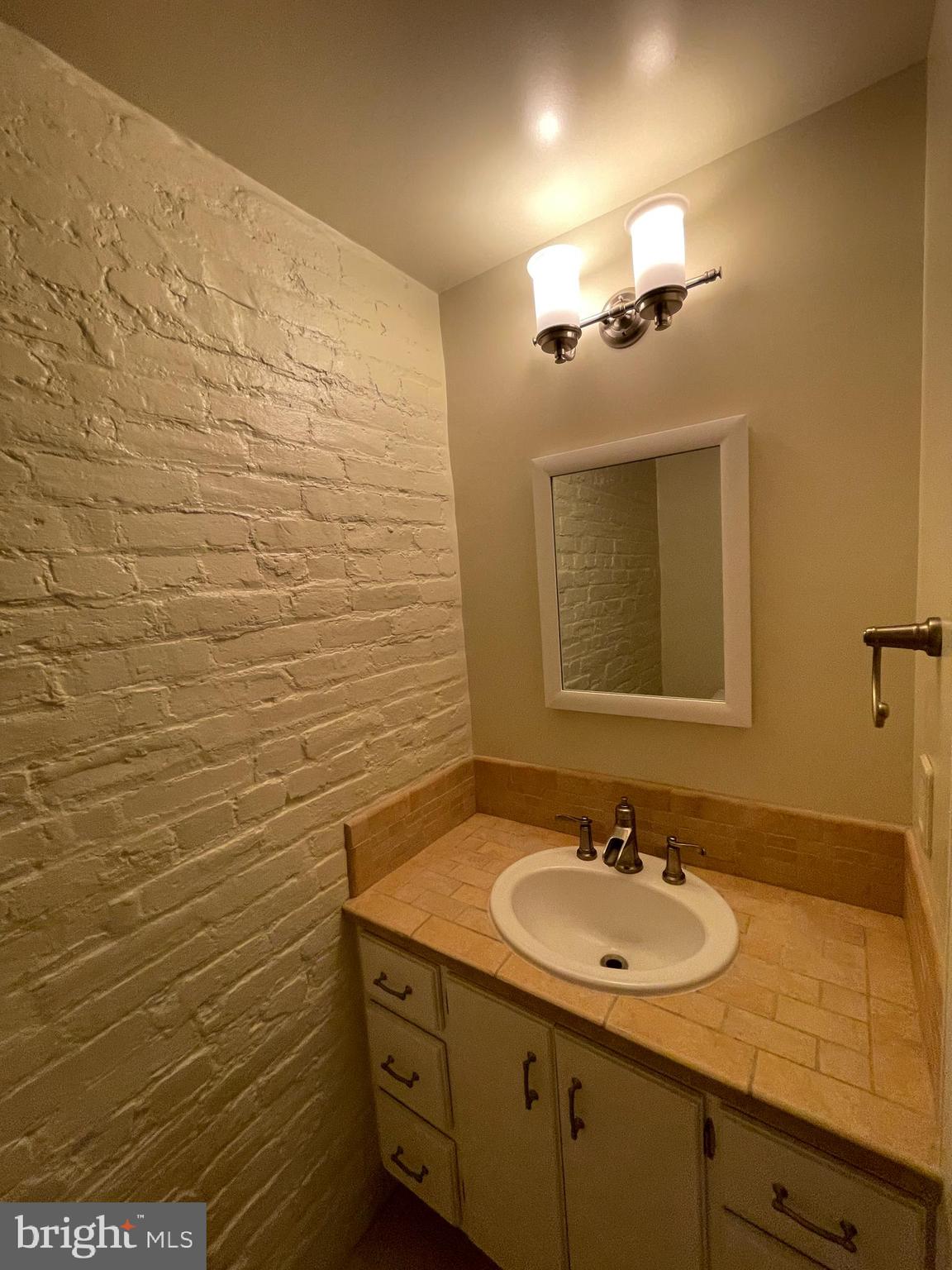 2442 20th Street Northwest, Unit B Washington, DC 20009 - Photo 10 of 19 a bathroom with a sink and a mirror