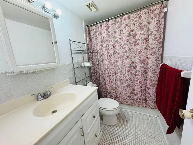 a bedroom with a bed and a ceiling fan