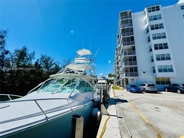 a view of a swimming pool with a lounge chair and palm trees