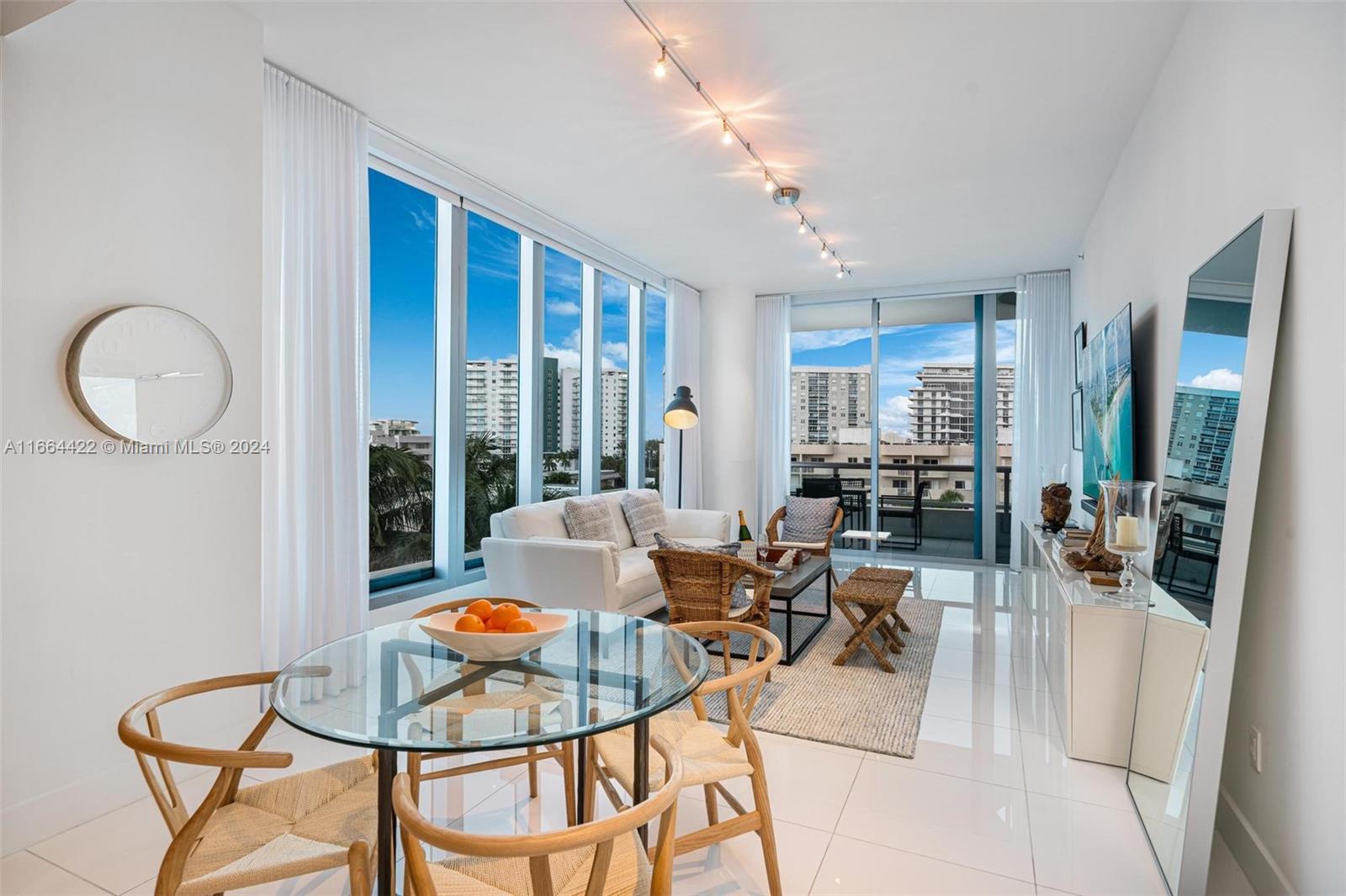 6799 Collins Avenue, Unit 411 Miami Beach, FL 33141 - Photo 1 of 21 a living room with furniture and a large window
