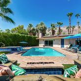 a view of a backyard with swimming pool and furniture