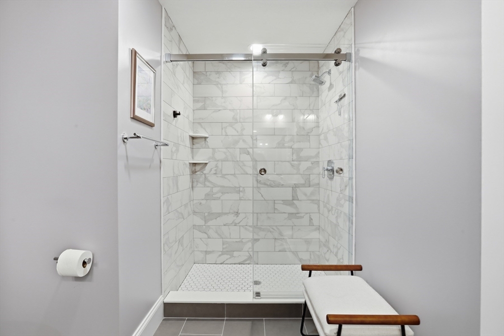 47 Cutter Lane, Unit 47 Amesbury, MA 01913 - Photo 16 of 33 a bathroom with a bathtub and shower