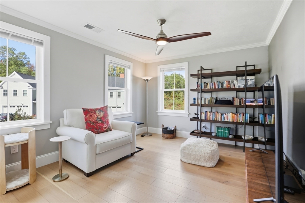 47 Cutter Lane, Unit 47 Amesbury, MA 01913 - Photo 20 of 33 a living room with furniture and a book shelf