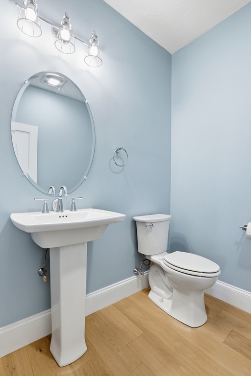 47 Cutter Lane, Unit 47 Amesbury, MA 01913 - Photo 26 of 33 a bathroom with a sink toilet and a mirror