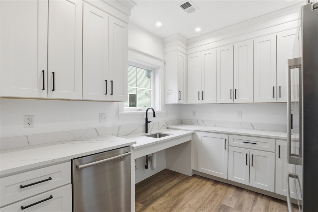 47 Cutter Lane, Unit 47 Amesbury, MA 01913 - Photo 31 of 33 a kitchen with white cabinets white appliances sink and dishwasher
