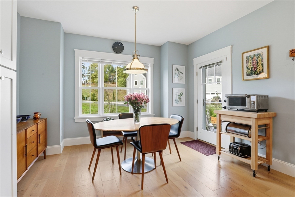47 Cutter Lane, Unit 47 Amesbury, MA 01913 - Photo 7 of 33 a view of a dining room with furniture window and wooden floor