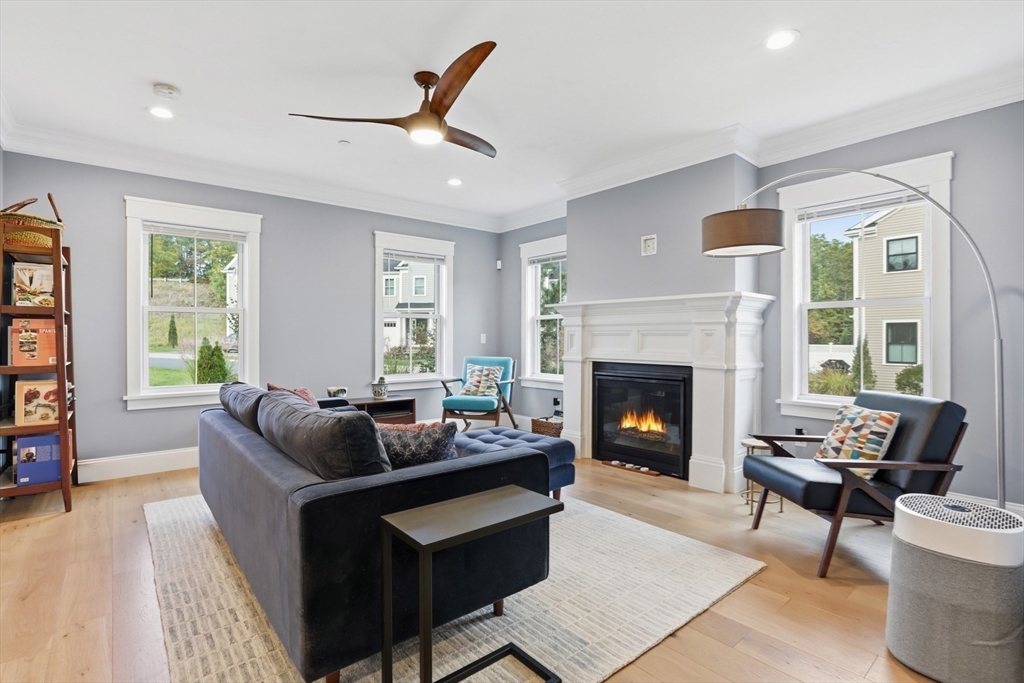 47 Cutter Lane, Unit 47 Amesbury, MA 01913 - Photo 9 of 33 a living room with furniture and a fireplace