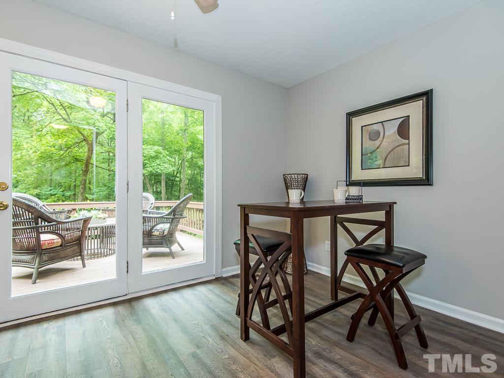 7014 Kemp Road Raleigh, NC 27613 - Photo 13 of 43 a view of a dining room with furniture wooden floor and a window
