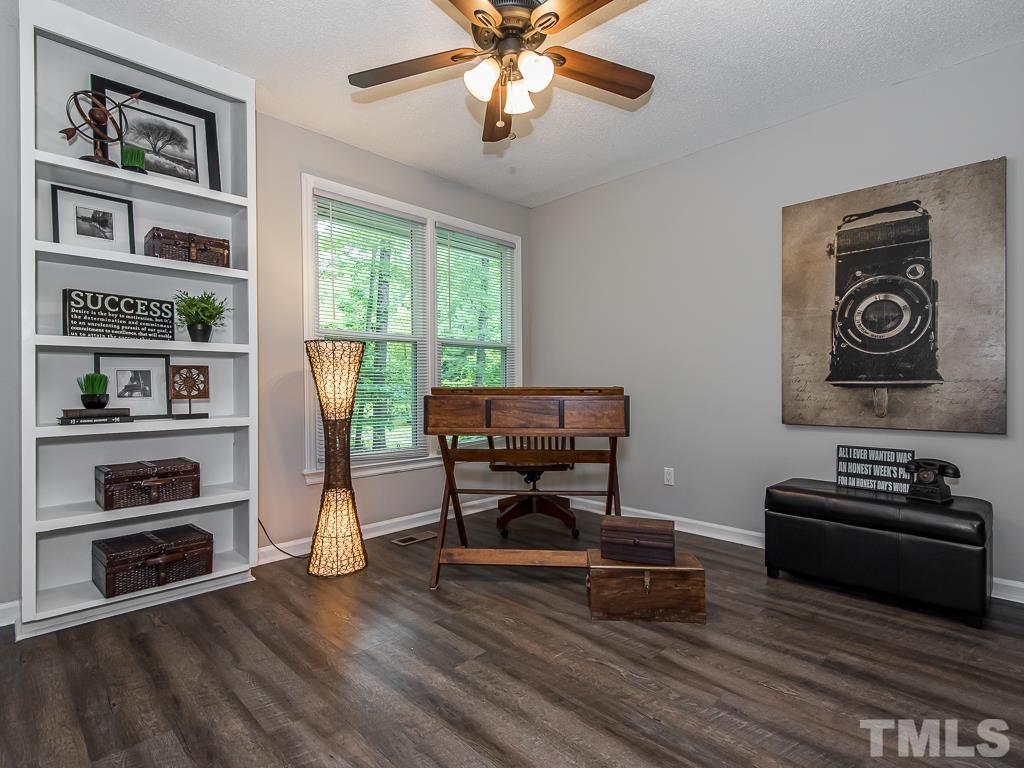 7014 Kemp Road Raleigh, NC 27613 - Photo 14 of 43 a living room with furniture and a wooden floor