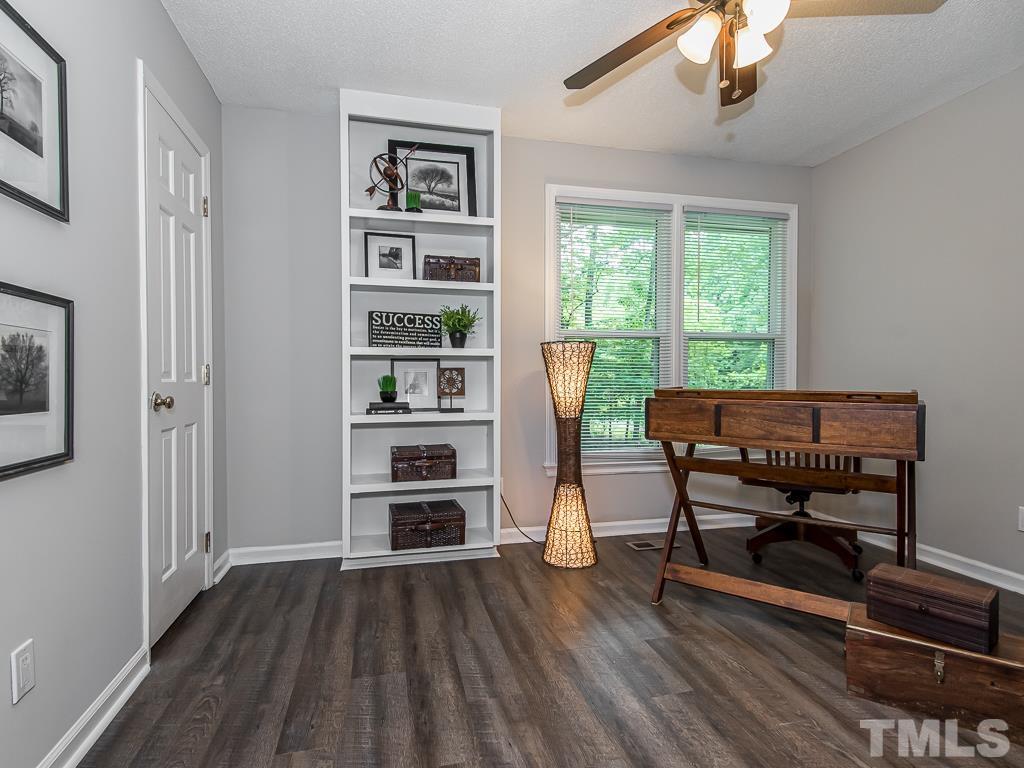 7014 Kemp Road Raleigh, NC 27613 - Photo 15 of 43 a view of a workspace with furniture and a window