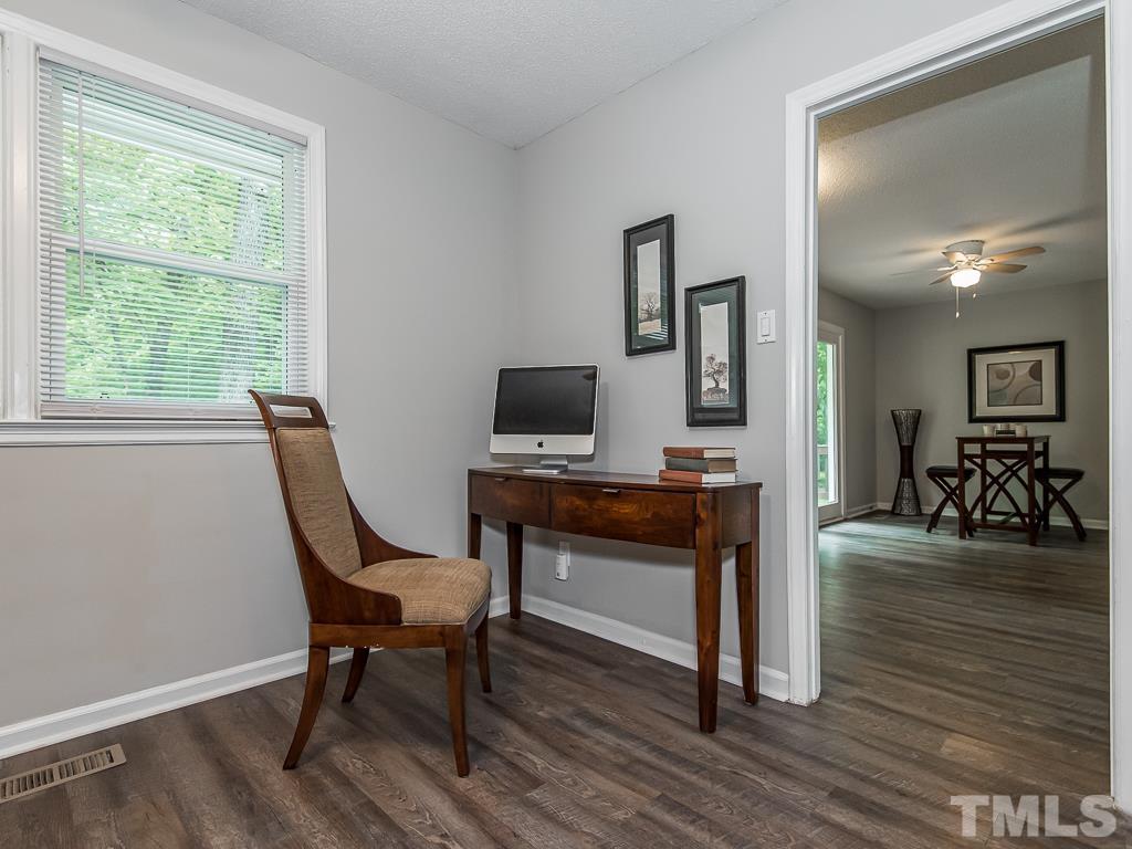 7014 Kemp Road Raleigh, NC 27613 - Photo 17 of 43 a view of a workspace with wooden floor and a window
