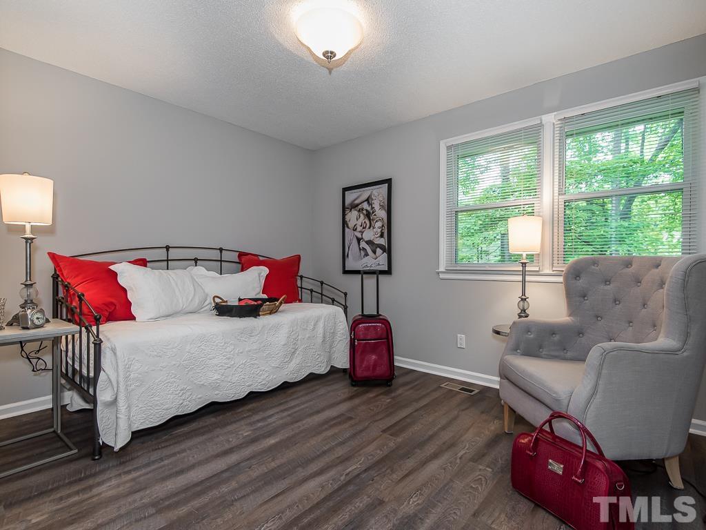 7014 Kemp Road Raleigh, NC 27613 - Photo 22 of 43 a bedroom with a bed and window