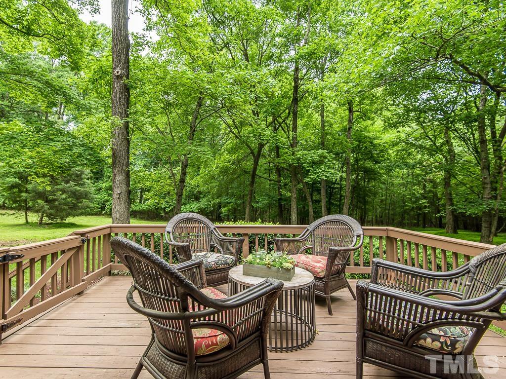 7014 Kemp Road Raleigh, NC 27613 - Photo 24 of 43 a view of a roof deck with table and chairs and wooden floor