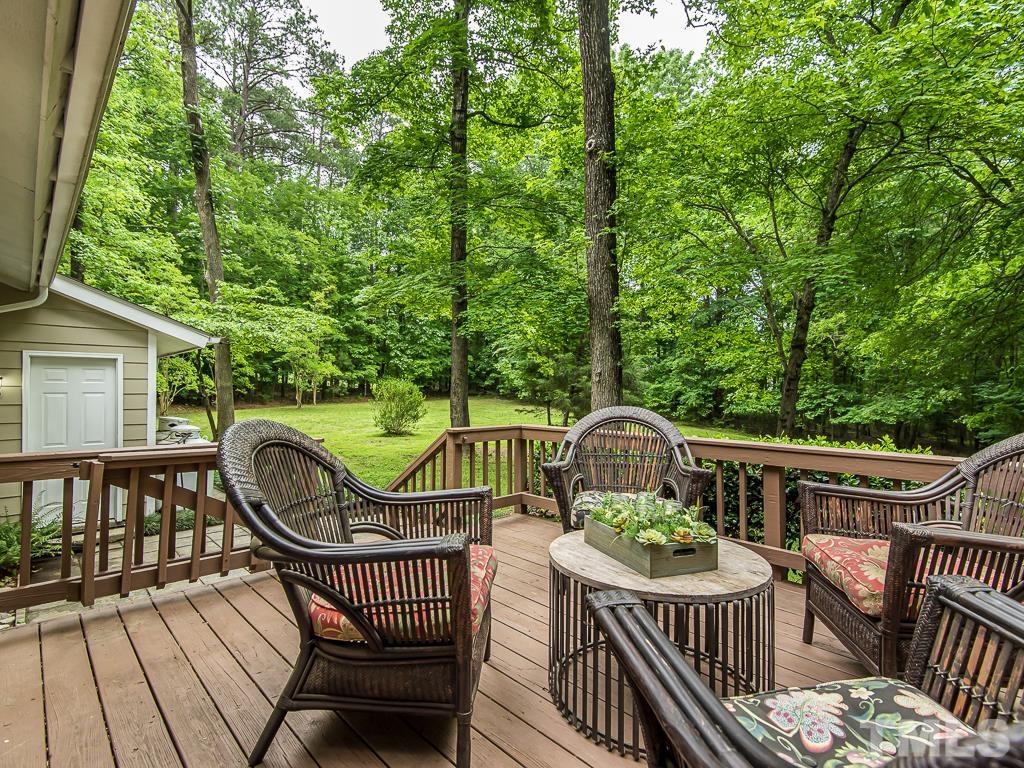 7014 Kemp Road Raleigh, NC 27613 - Photo 26 of 43 a view of a wooden deck with furniture
