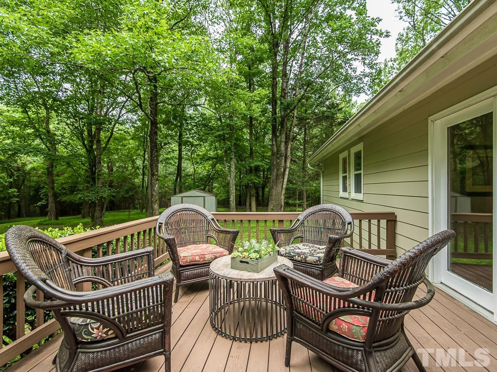 7014 Kemp Road Raleigh, NC 27613 - Photo 27 of 43 a view of a chair and table on the deck