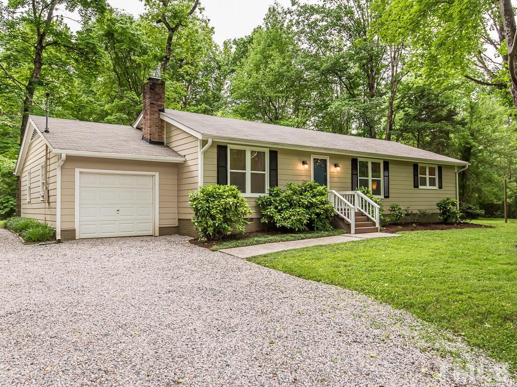 7014 Kemp Road Raleigh, NC 27613 - Photo 29 of 43 a front view of a house with a garden and yard