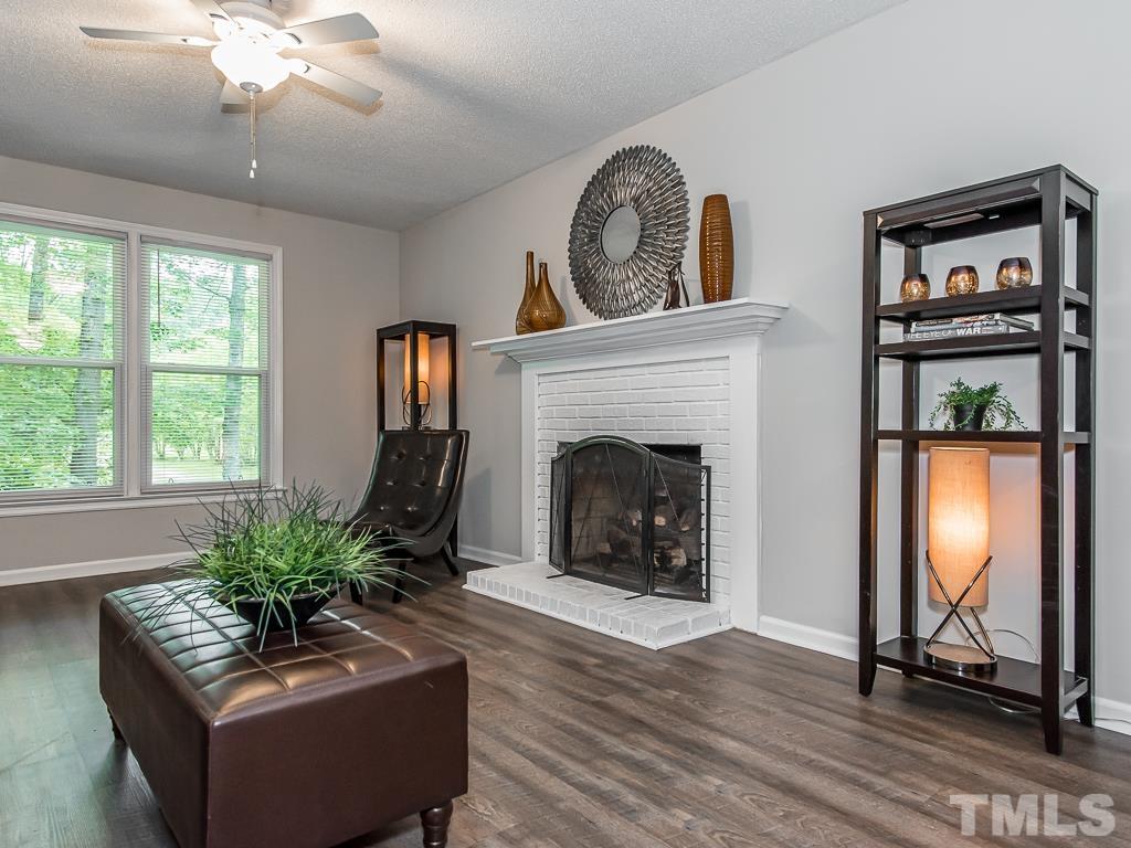 7014 Kemp Road Raleigh, NC 27613 - Photo 3 of 43 a living room with furniture and a fireplace