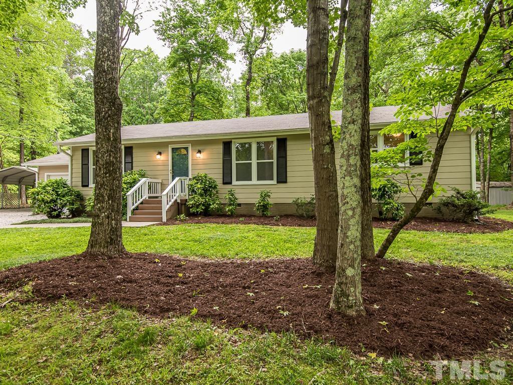 7014 Kemp Road Raleigh, NC 27613 - Photo 31 of 43 a view of a yard in front of a house with large windows