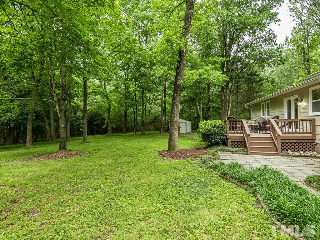 7014 Kemp Road Raleigh, NC 27613 - Photo 37 of 43 a view of a chair and tables in the back yard