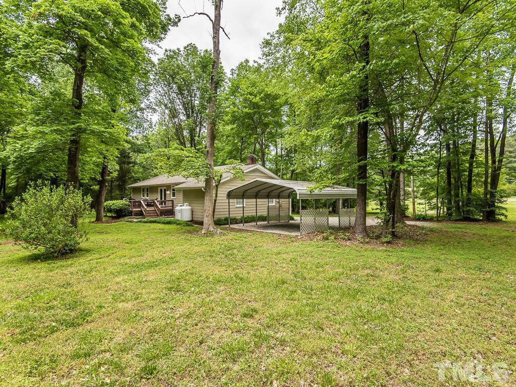 7014 Kemp Road Raleigh, NC 27613 - Photo 38 of 43 a house with trees in the background