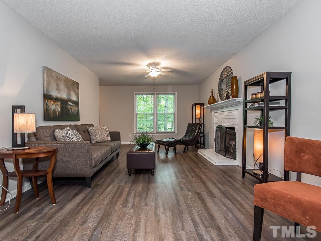 7014 Kemp Road Raleigh, NC 27613 - Photo 4 of 43 a living room with furniture and a fireplace