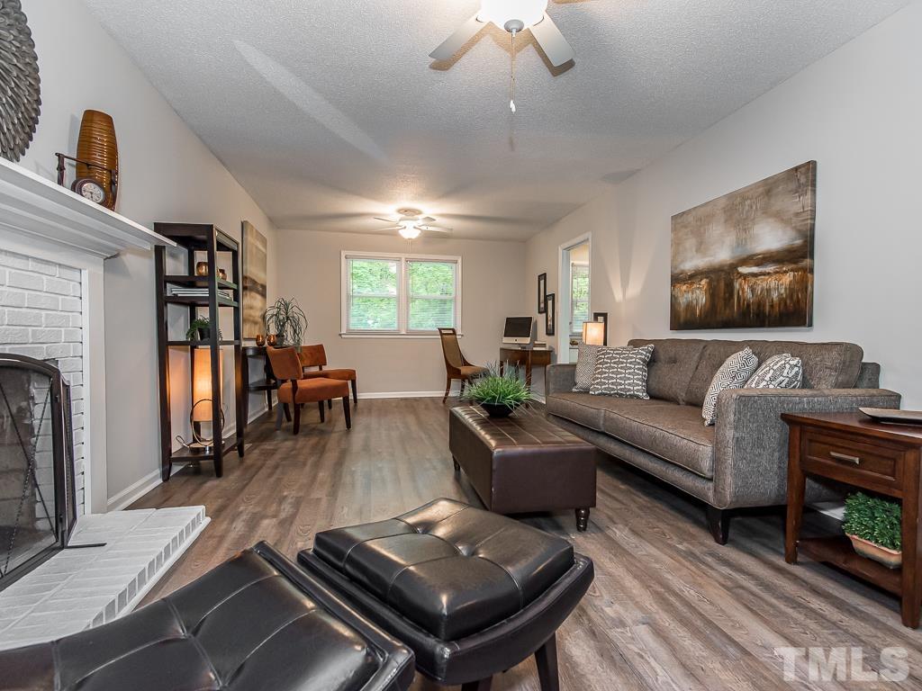 7014 Kemp Road Raleigh, NC 27613 - Photo 5 of 43 a living room with furniture and a fireplace