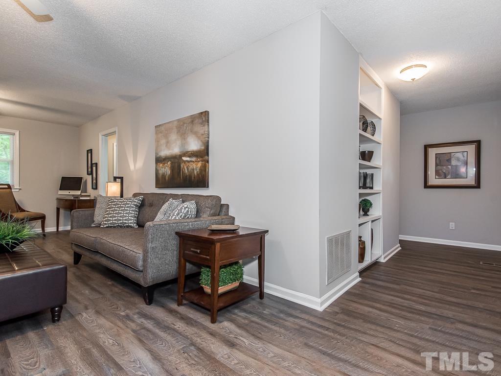 7014 Kemp Road Raleigh, NC 27613 - Photo 6 of 43 a living room with furniture and a wooden floor