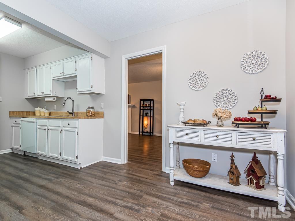 7014 Kemp Road Raleigh, NC 27613 - Photo 7 of 43 a kitchen with a stove and cabinets