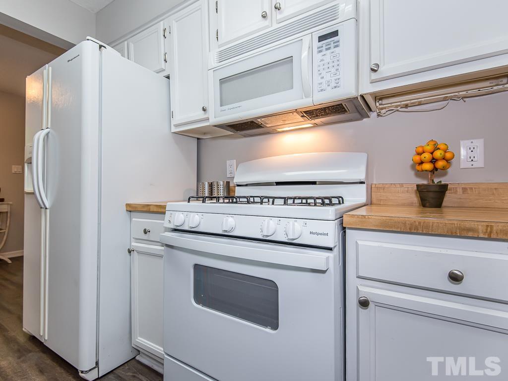 7014 Kemp Road Raleigh, NC 27613 - Photo 9 of 43 a kitchen with stainless steel appliances cabinets and a window
