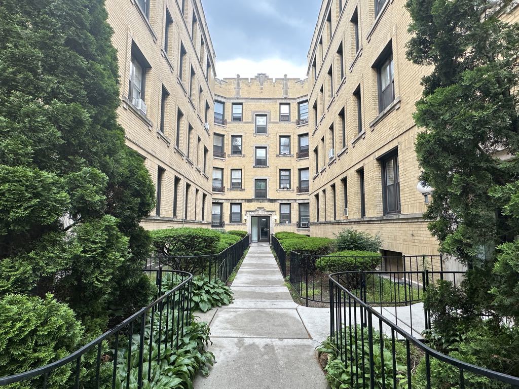 4606 North Beacon Street, Unit 2C Chicago, IL 60640 - Photo 1 of 21 front view of a brick building with large windows
