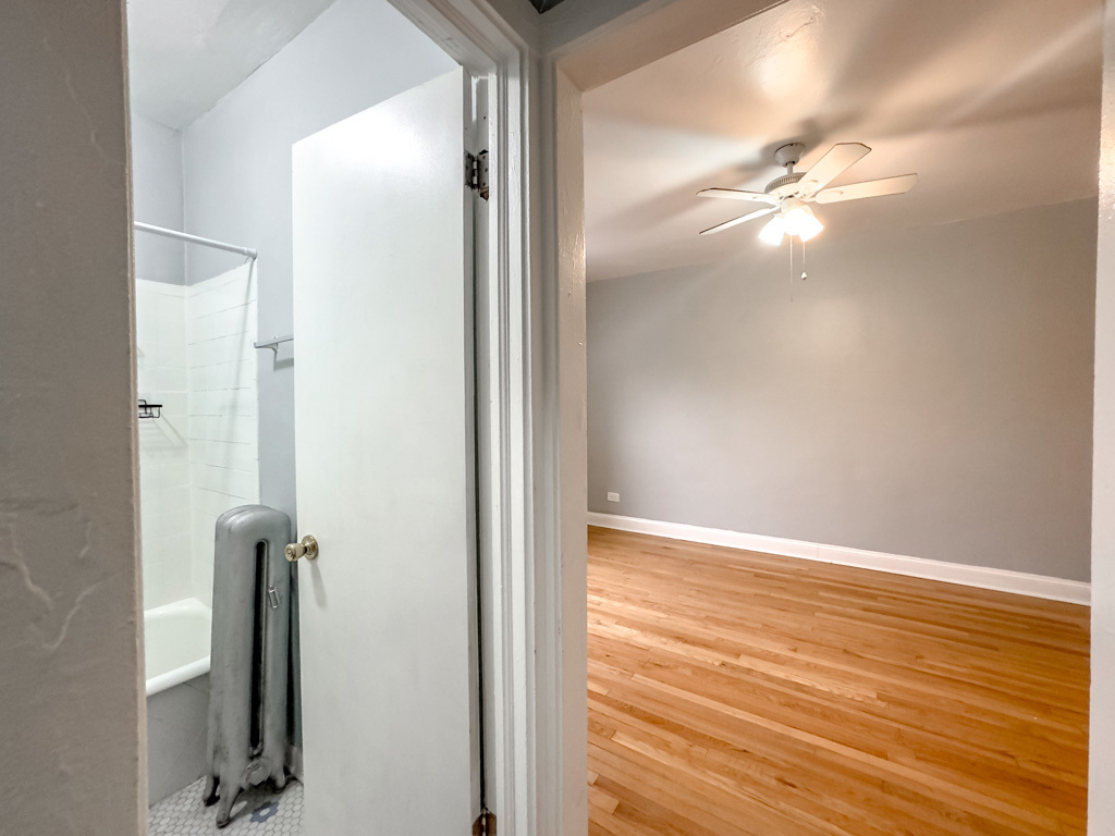 4606 North Beacon Street, Unit 2C Chicago, IL 60640 - Photo 14 of 21 wooden floor in an empty room