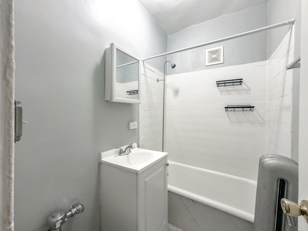 4606 North Beacon Street, Unit 2C Chicago, IL 60640 - Photo 16 of 21 a bathroom with a shower and a sink