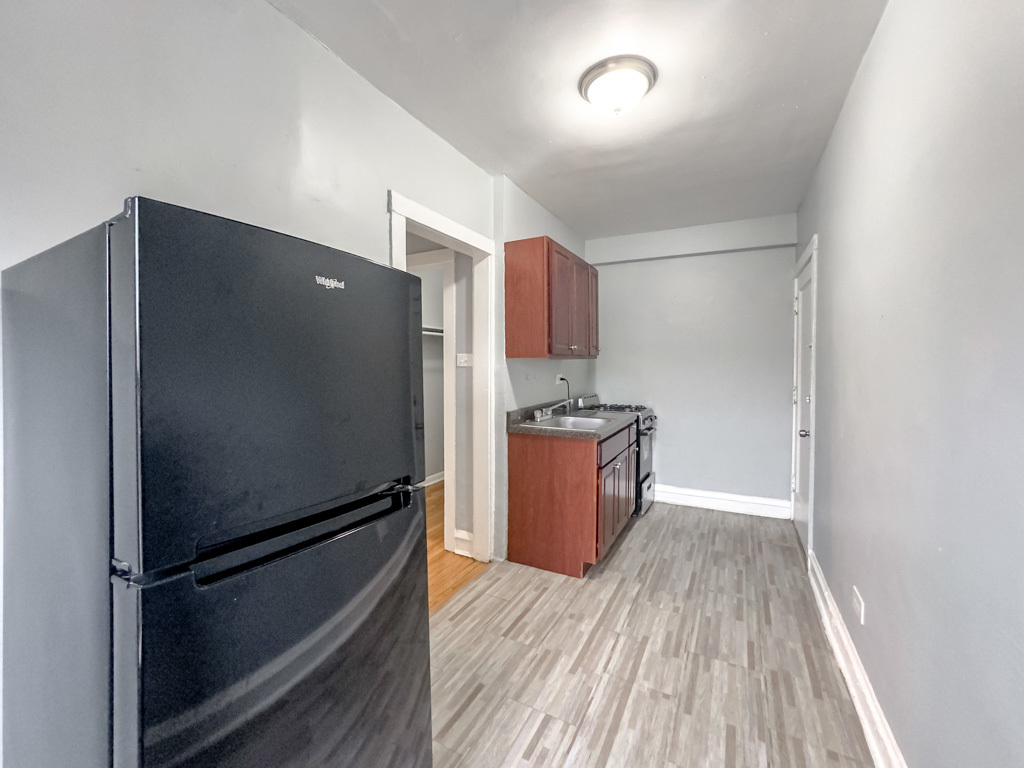 4606 North Beacon Street, Unit 2C Chicago, IL 60640 - Photo 7 of 21 a kitchen with stainless steel appliances a refrigerator and a stove top oven