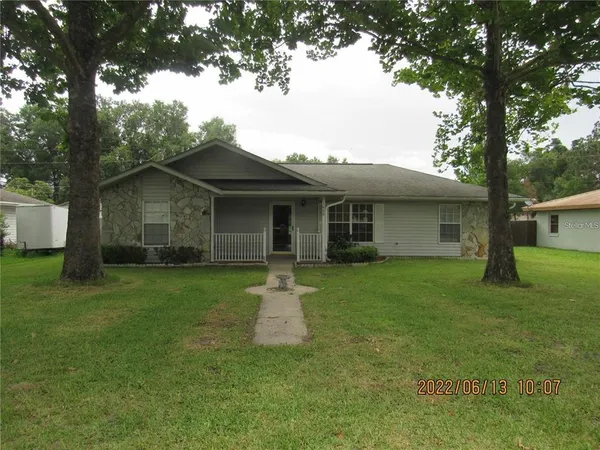 a front view of house with yard and green space