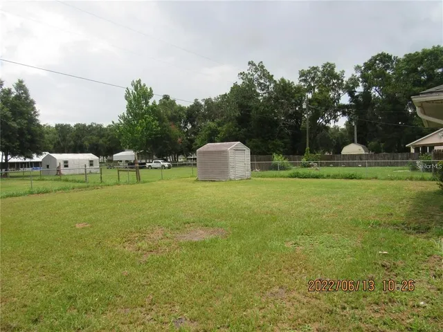 a view of a park with large trees