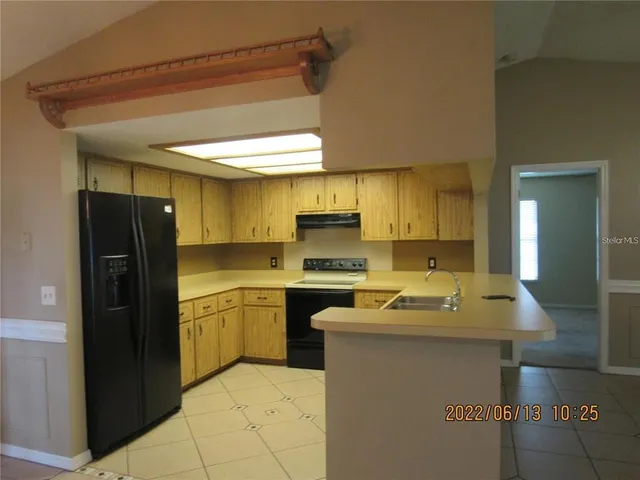 a kitchen with a sink appliances and cabinets