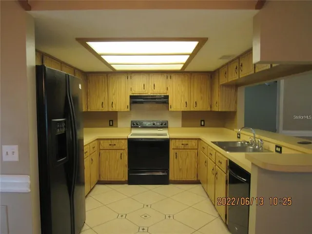 a kitchen with a stove sink and a refrigerator