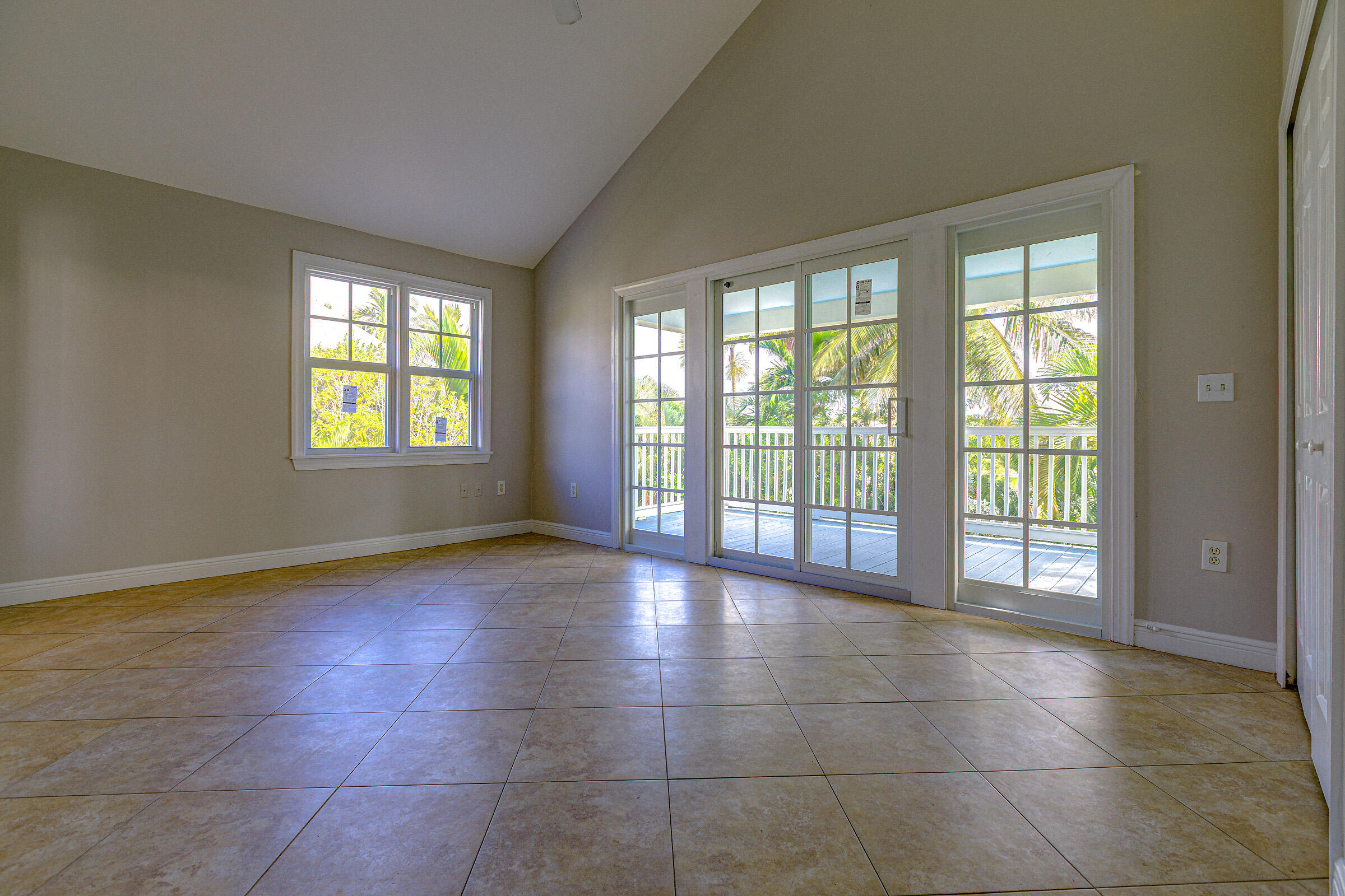 249 Golf Club Drive Key West, FL 33040 - Photo 7 of 11 a view of an empty room with glass door and glass door