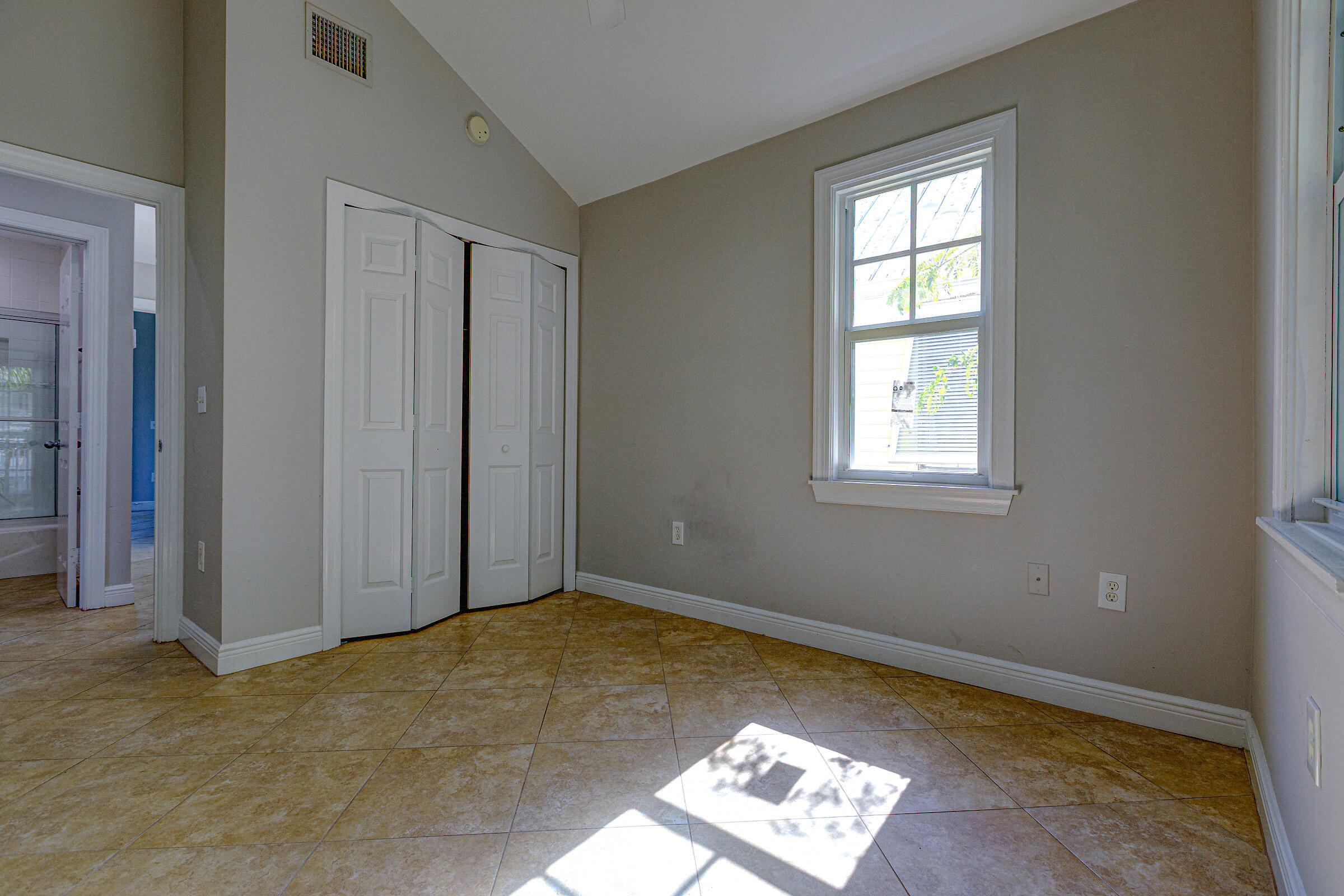 249 Golf Club Drive Key West, FL 33040 - Photo 9 of 11 a view of an empty room with a window