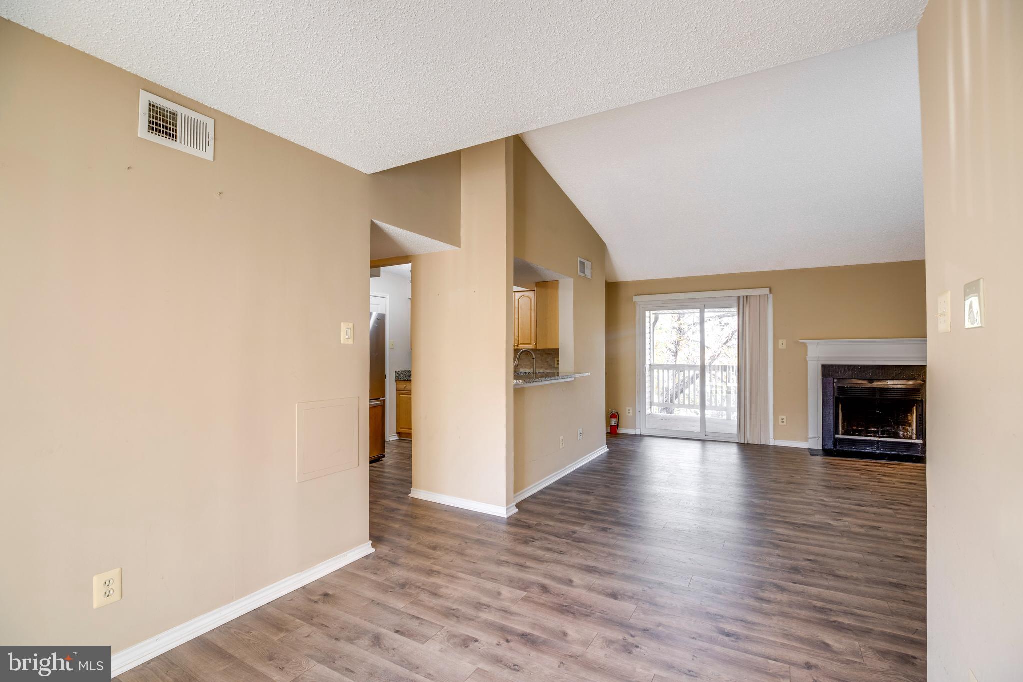 1543 Lincoln Way, Unit 301B McLean, VA 22102 - Photo 13 of 30 a view of a livingroom with wooden floor and a fireplace