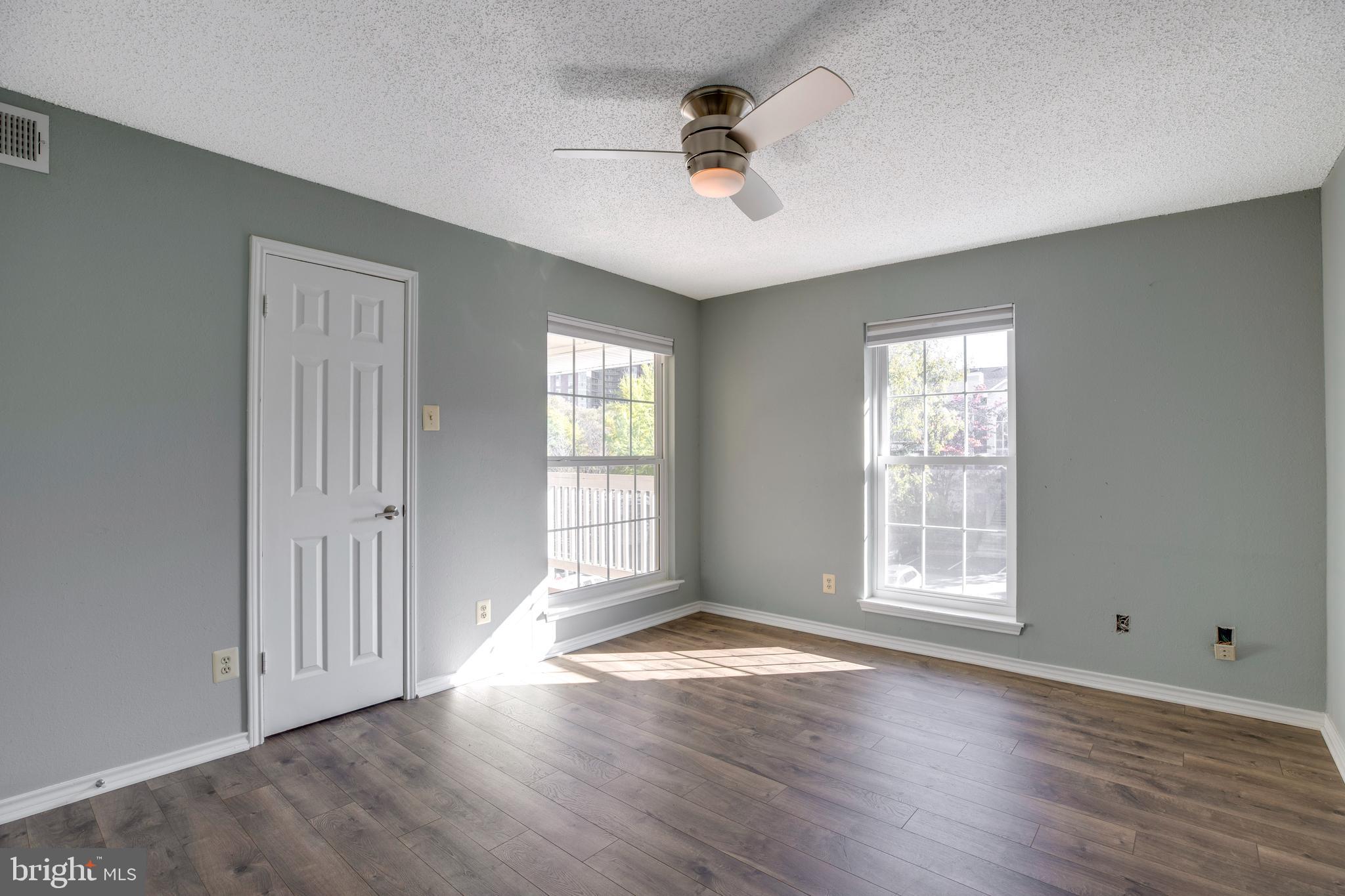 1543 Lincoln Way, Unit 301B McLean, VA 22102 - Photo 16 of 30 an empty room with wooden floor and windows