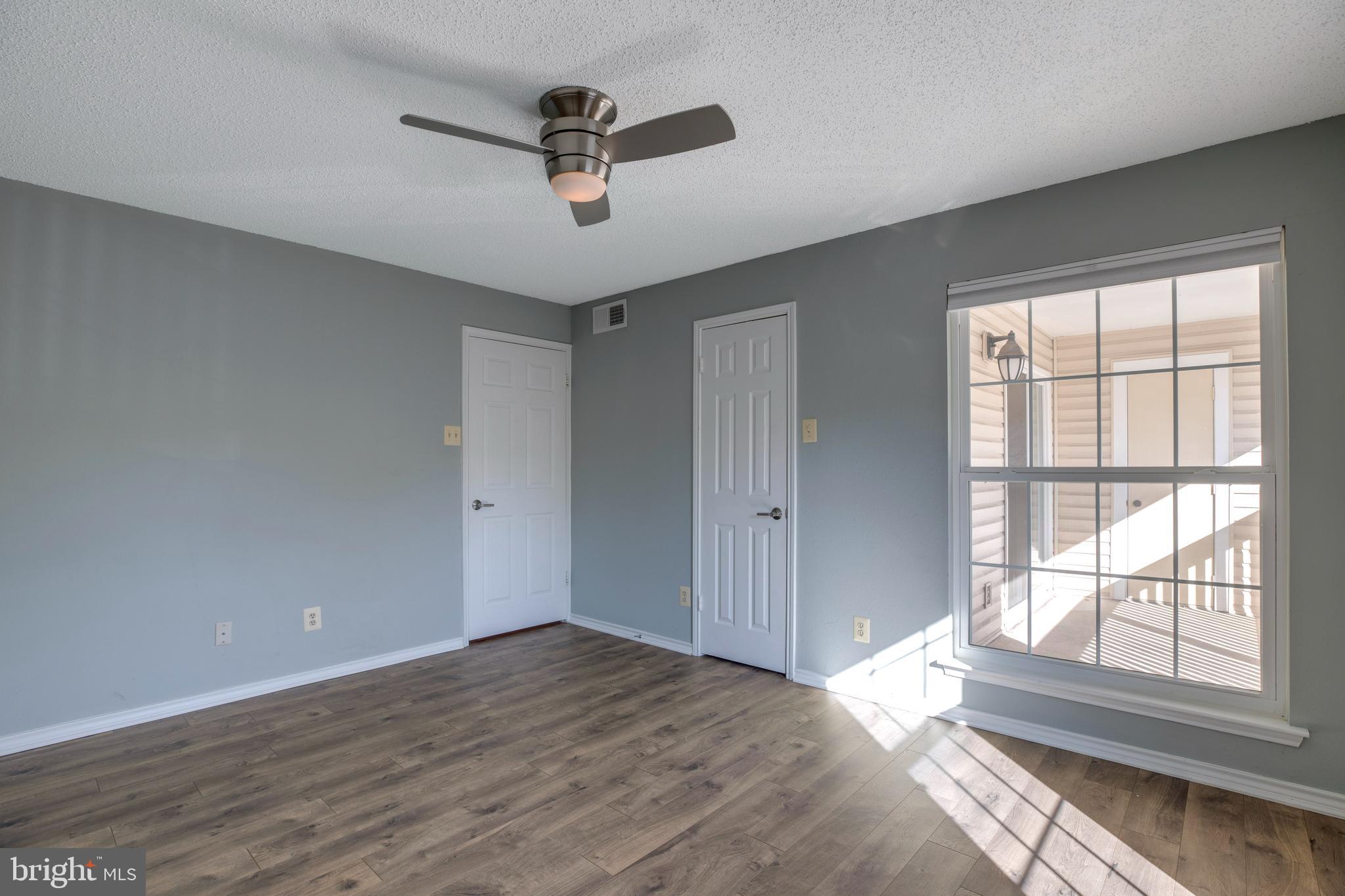 1543 Lincoln Way, Unit 301B McLean, VA 22102 - Photo 17 of 30 a view of empty room with wooden floor and fan