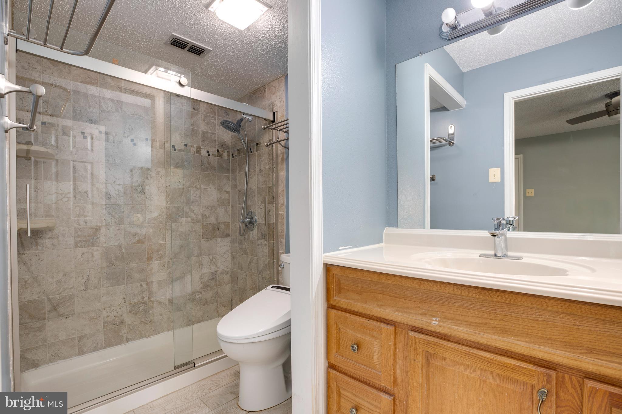 1543 Lincoln Way, Unit 301B McLean, VA 22102 - Photo 22 of 30 a bathroom with a sink a toilet and shower