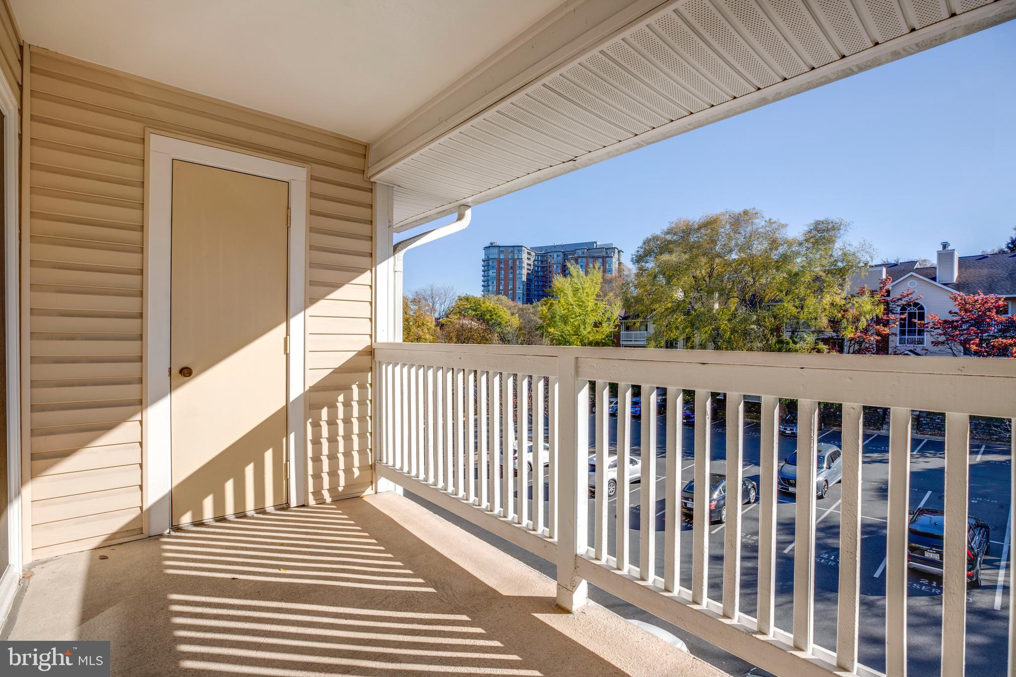 1543 Lincoln Way, Unit 301B McLean, VA 22102 - Photo 26 of 30 a view of a balcony with wooden floor and fence