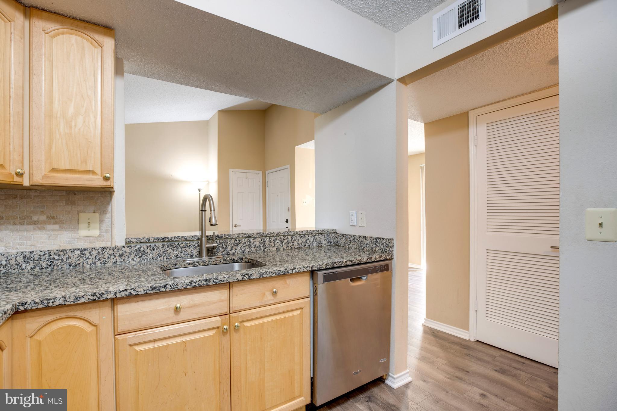 1543 Lincoln Way, Unit 301B McLean, VA 22102 - Photo 4 of 30 a bathroom with a granite countertop sink and a mirror