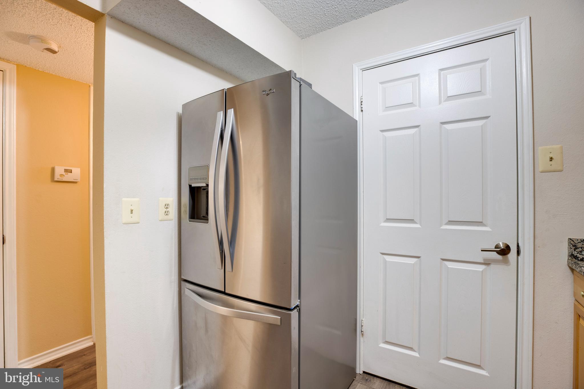 1543 Lincoln Way, Unit 301B McLean, VA 22102 - Photo 5 of 30 a metallic refrigerator freezer sitting in a kitchen